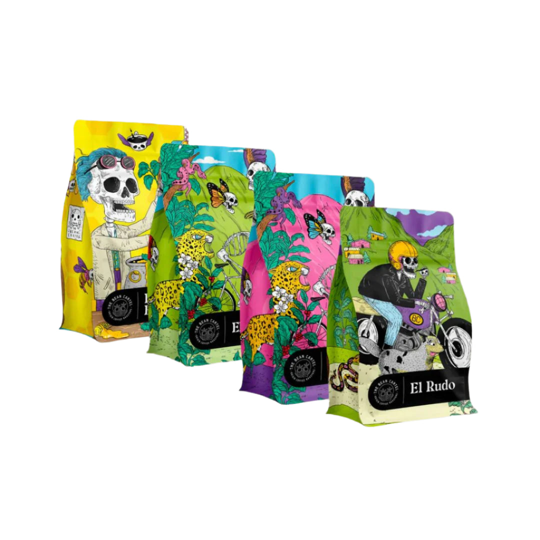 Roasted coffee by The Roast Collective. Images shows a collection of the Bean Cartel's four main blend offerings: Dr. Chan's Elixir, El Capitán, La Patrona, and El Rudo, in a downward overlapping arrangement from left to right. The bags are all 250g bags and each feature their own distinctive, exciting colourful design with a central 'Cinco de mayo' style theme. The bags are set against a white background.