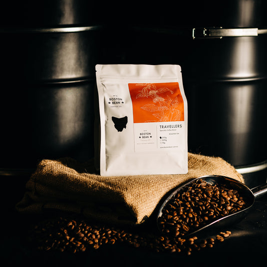 Roasted coffee beans The Boston Bean Coffee Co. Travellers Blend 250g bag on coffee sack The Roast Collective