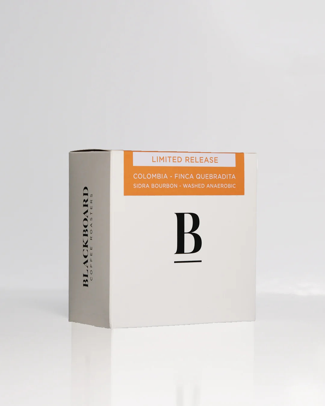 Roasted coffee beans. Blackboard Coffee Roasters, May 2025 Limited Release - Colombia, Finca Quebradita, washed anaerobic sidra bourbon. Image shows a white 200g box against a white background. The box features the Blackboard logo centred on the front, with the product description on a orange coloured sticker at the top of the front of the box. The Roast Collective.