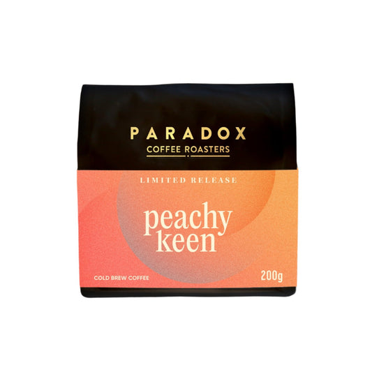 Roasted coffee beans Paradox Coffee Roasters Limited Edition: Peachy Keen 200g bag Cold Brew Coffee. White background. The Roast Collective.