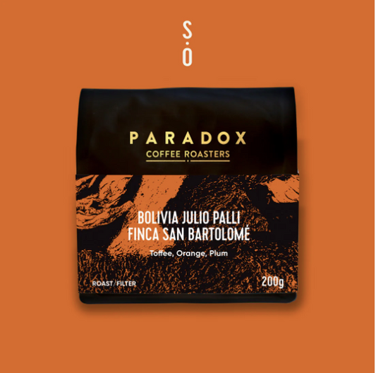 Paradox Coffee Roasters packaging on an orange background
