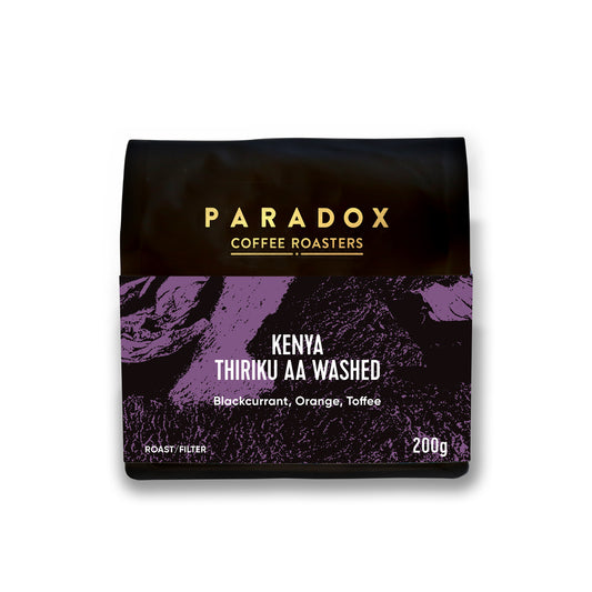 Roasted coffee beans. Paradox Coffee Roasters, Kenya - Thiriku AA Washed. Filter roast only. Image shows a 200g bag against a white background. The Roast Collective.
