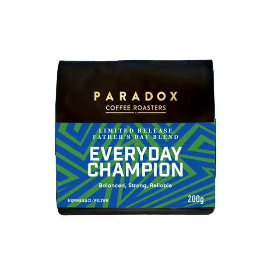 A coffee roaster package labeled PARADOX COFFEE ROASTERS Everyday Champion, shown centered on a blue and green geometric background with the text LIMITED RELEASE and flavor notes Passionfruit, Chocolate, Blackberry, Mandarin.