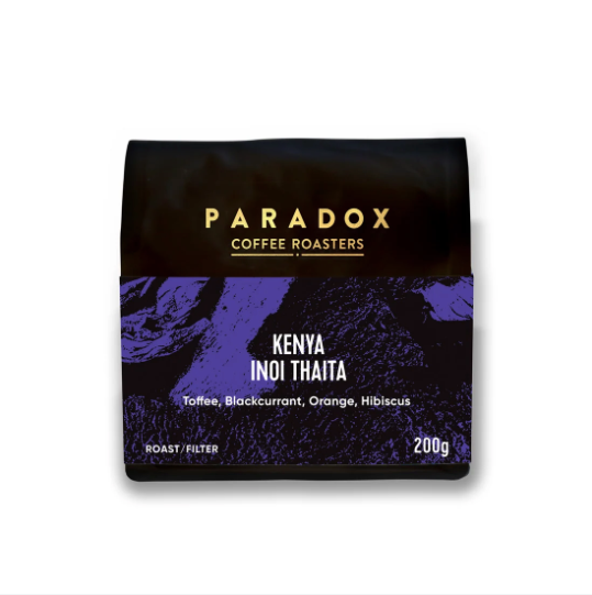 A 200g bag of Paradox Coffee Roasters Kenya Inoi Thaita coffee, featuring a black and purple textured design with gold and white text, set against a plain white background.