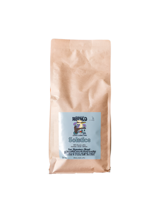 Roasted coffee beans from The Roast Collective. That's Whyld Coffee Roasters, Solstice Organic Blend. Image shows a brown 1kg bag of Solstice blend against a white background. The bag has a duck egg blue coloured label centred on the lower half of the bag with the roaster's logo, blend name, and blend details on it. 
