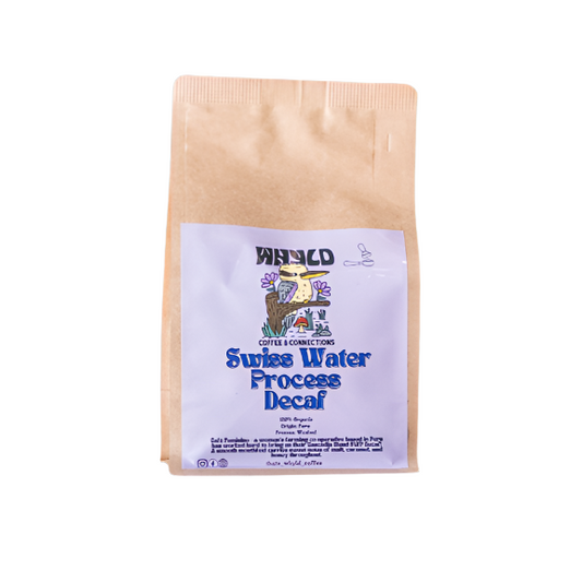 Roasted coffee beans from The Roast Collective. That's Whyld Coffee Roasters, Café Feminino Organic Decaf. Image shows a brown 250g bag of Café Feminino against a white background. The bag has a lavender coloured label centred on the lower half of the bag with the roaster's logo, blend name, and blend details on it. 