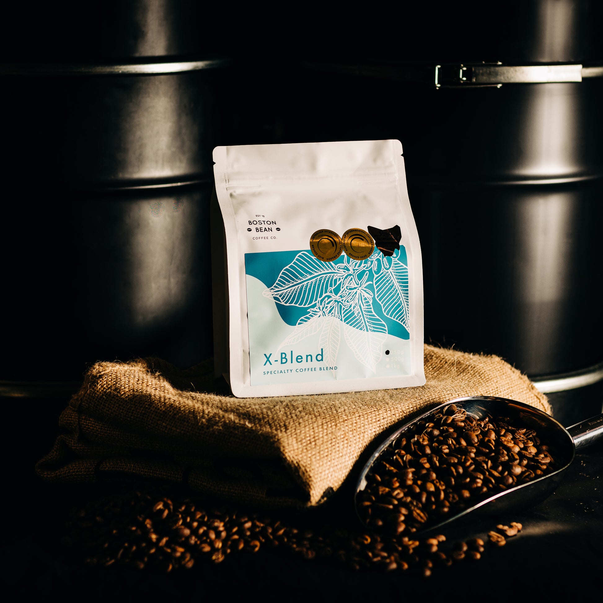 Roasted coffee beans The Boston Bean Coffee Co. X-Blend Blend 250g bag on coffee sack The Roast Collective